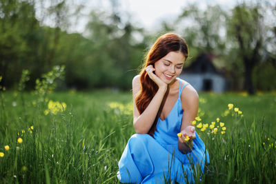 Young woman sitting on field