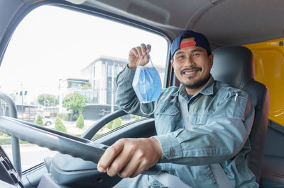 Man smiling while sitting in car