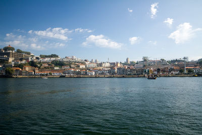 View of townscape by sea against sky