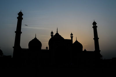 Silhouette of building at sunset