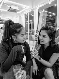 Portrait of smiling friends sitting at restaurant