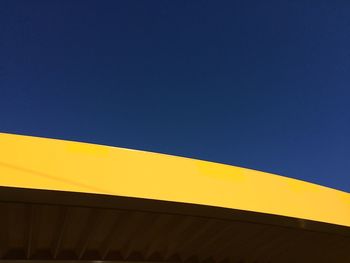 Low angle view of built structure against clear blue sky