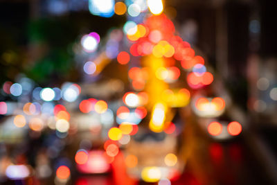 Defocused image of illuminated christmas lights at night