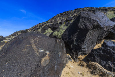 Low angle view of rock formations against sky