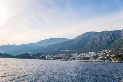 Scenic view of river and mountains against sky