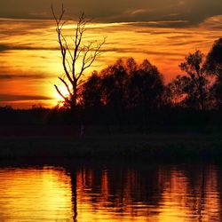 Scenic view of lake at sunset