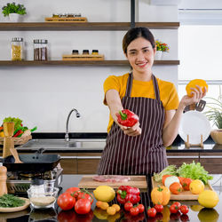 Portrait of smiling woman standing at market stall