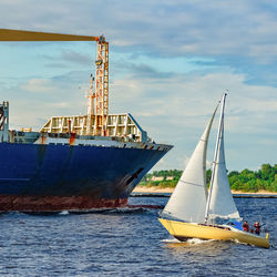 Sailboat sailing on sea against sky