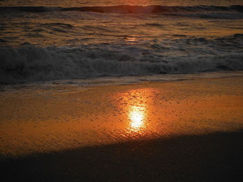 Scenic view of beach against sky during sunset