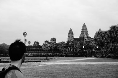 Rear view of man on temple against building