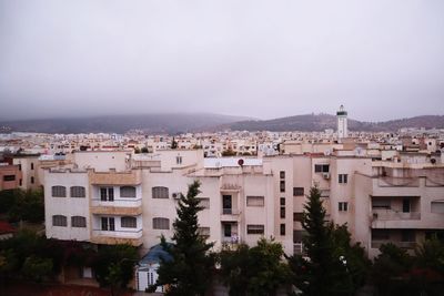 Buildings in city against clear sky