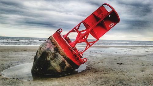 Lifeguard hut on beach against sky