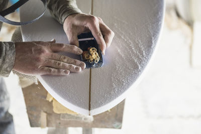 Surfboard shaper refining a new design