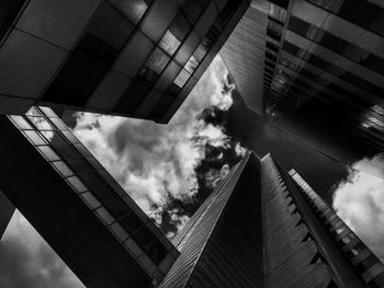 Low angle view of modern building against cloudy sky