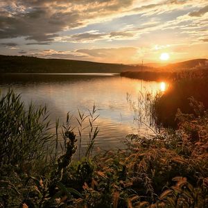 Scenic view of lake against sky during sunset