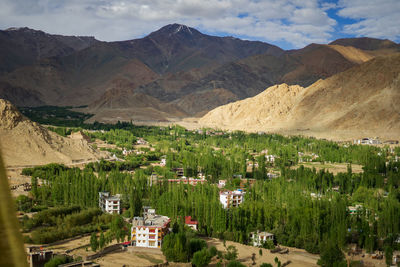 High angle view of townscape and mountains against sky