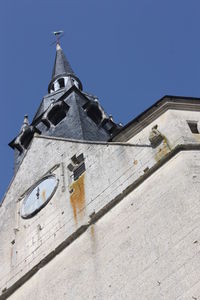 Low angle view of bell tower against sky