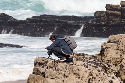 Full length of man on rock at beach