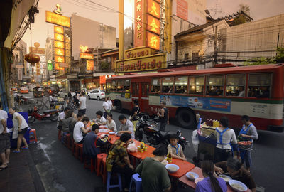 People having snacks at sidewalk cafe