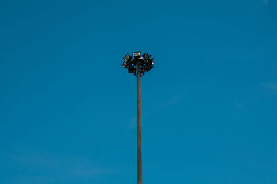 Low angle view of street light against blue sky