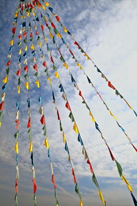 Low angle view of multi colored decoration hanging against sky