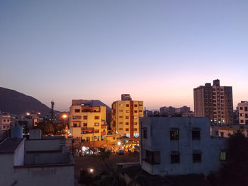 High angle view of illuminated buildings against sky at sunset