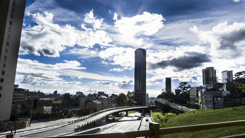 Skyscrapers against cloudy sky