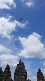 Low angle view of airplane flying against sky