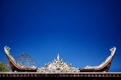 Low angle view of building against clear blue sky