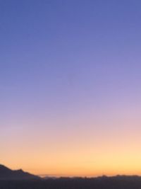 Scenic view of silhouette landscape against clear sky during sunset