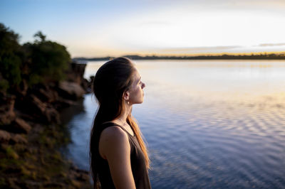 Relaxed woman enjoying watching the sunset outdoors.