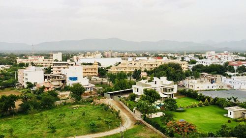 High angle view of houses in town against sky