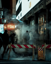 People walking on street at night