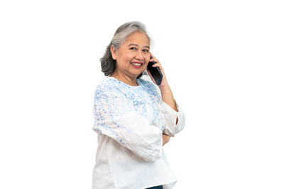 Portrait of a smiling young woman against white background