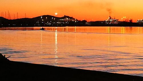 Scenic view of sea against orange sky