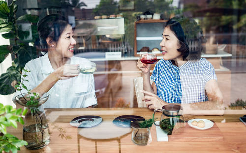 Smiling woman with drink on table