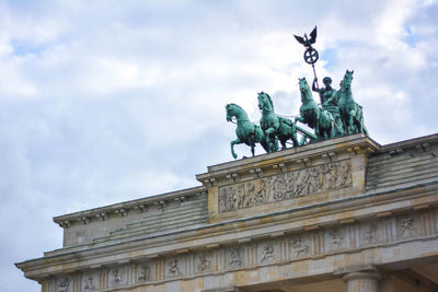 Low angle view of statue against cloudy sky