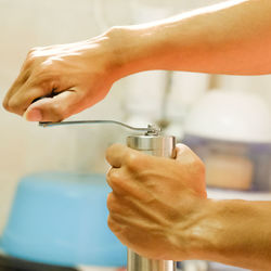 Close-up of hands holding peppermill