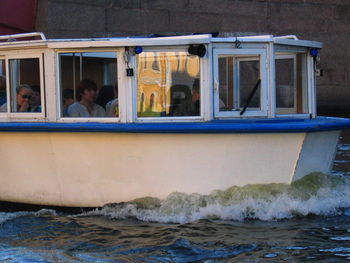 Reflection of man in boat on sea