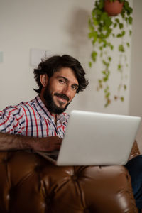 Young business man working  with laptop. gray notebook for working. home office