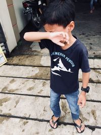 High angle view of boy standing outdoors