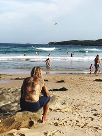 People on beach against sky