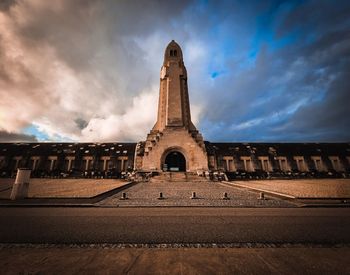 Low angle view of building against cloudy sky