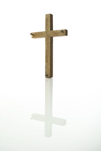 Close-up of cross against white background