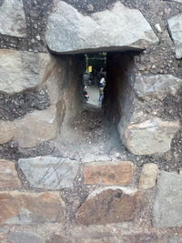 Rear view of woman walking on rock