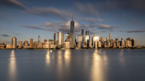 Modern buildings in city against cloudy sky