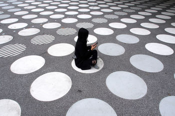 High angle view of woman sitting on street