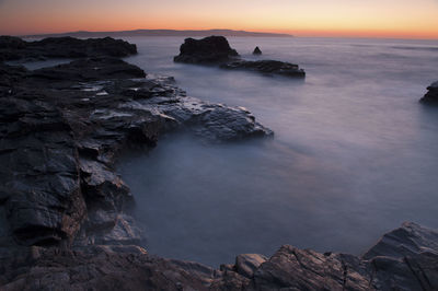 View of coastline at sunset