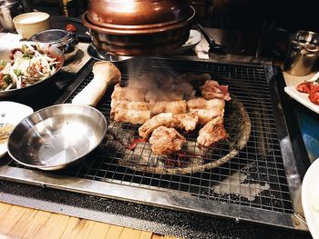 High angle view of meat on barbecue grill