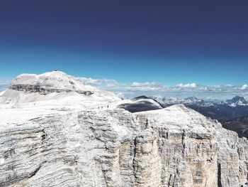 Scenic view of snowcapped mountains against clear blue sky